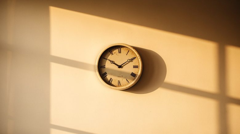 Vintage analog wall clock at golden hour symbolizing time remaining